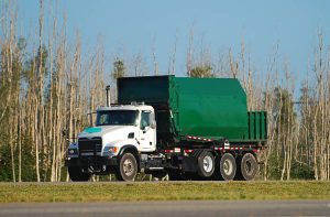 Green colored waste removal truck